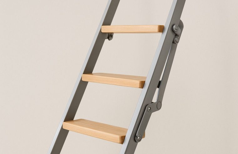 Close-up of a modern loft ladder with wooden steps and metal frame against a neutral background